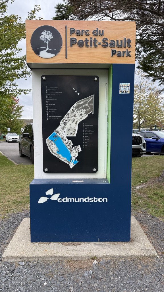 Signpost displaying the map and information for Parc du Petit-Sault Park in Edmundston, Canada.